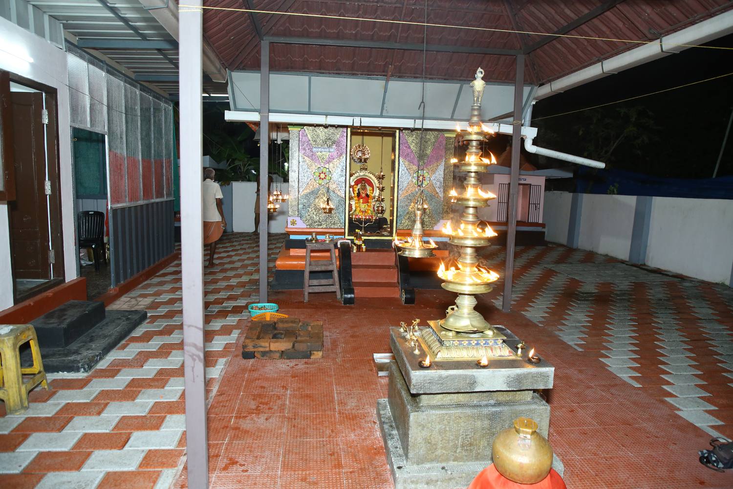 Sri Bhadrakali sanctum lit with oil lamps at the Kachaparambil temple
